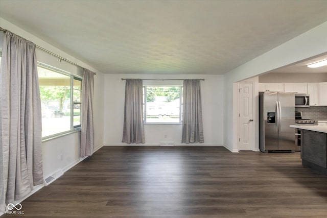 802 Lawrence Ave, Indianapolis, IN 46227 - unfurnished living room with dark wood-type flooring and baseboards