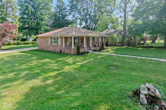 802 Lawrence Ave, Indianapolis, IN 46227 - ranch-style home with covered porch, a front lawn, and brick siding