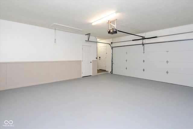802 Lawrence Ave, Indianapolis, IN 46227 - garage with a garage door opener and a wainscoted wall