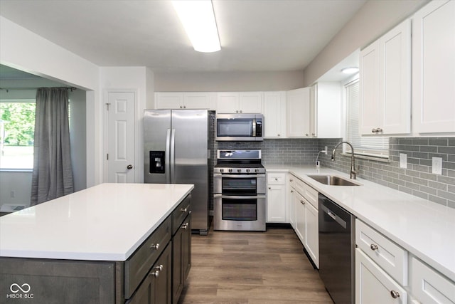 802 Lawrence Ave, Indianapolis, IN 46227 - kitchen with stainless steel appliances, white cabinetry, light countertops, decorative backsplash, and dark wood-type flooring