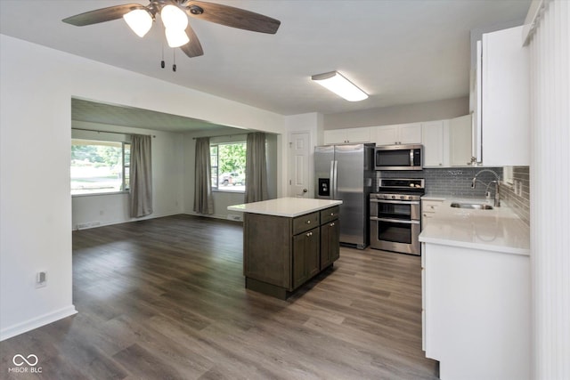 802 Lawrence Ave, Indianapolis, IN 46227 - kitchen with appliances with stainless steel finishes, light countertops, a center island, open floor plan, and wood finished floors