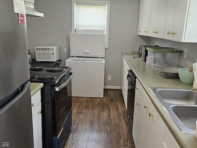 1601 S Biltmore Ave, Muncie, IN 47302 - kitchen with freestanding refrigerator, black range with electric cooktop, dark wood finished floors, white cabinetry, and light countertops