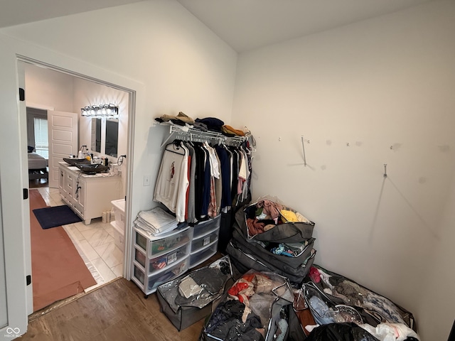 1720 Rembrandt St, Indianapolis, IN 46202 - walk in closet featuring vaulted ceiling and wood finished floors