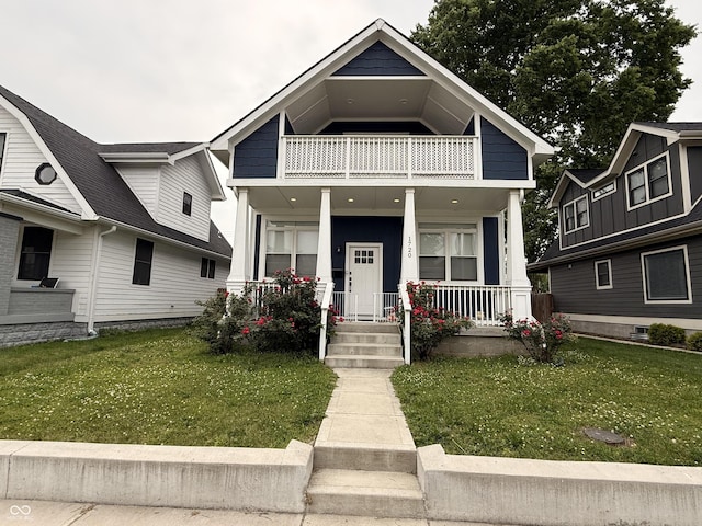 1720 Rembrandt St, Indianapolis, IN 46202 - view of front of property with a balcony, covered porch, and a front lawn