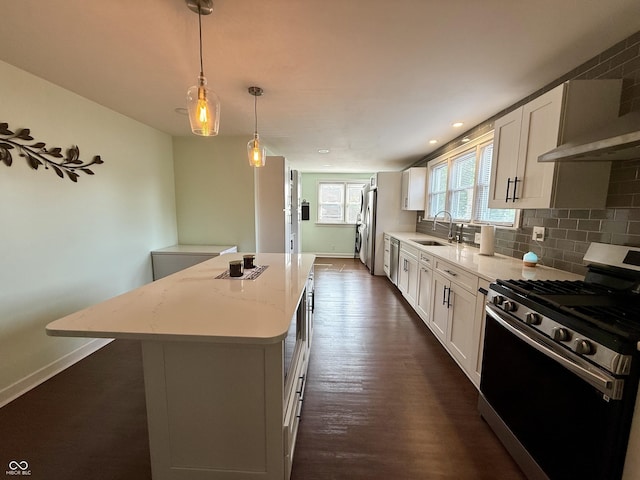 820 N Broadway St, Greensburg, IN 47240 - kitchen with stainless steel range with gas stovetop, a kitchen island, white cabinetry, dark wood-style flooring, and light stone counters