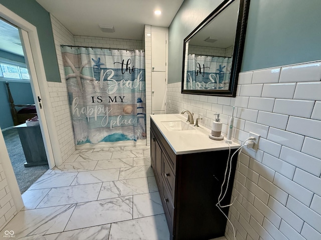 820 N Broadway St, Greensburg, IN 47240 - bathroom with tile walls, marble look tiles, vanity, curtained shower, and wainscoting