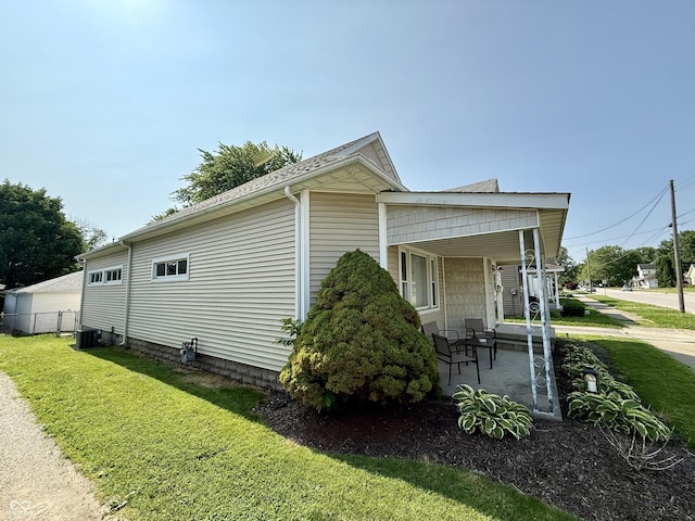 820 N Broadway St, Greensburg, IN 47240 - view of side of home with covered porch and a yard