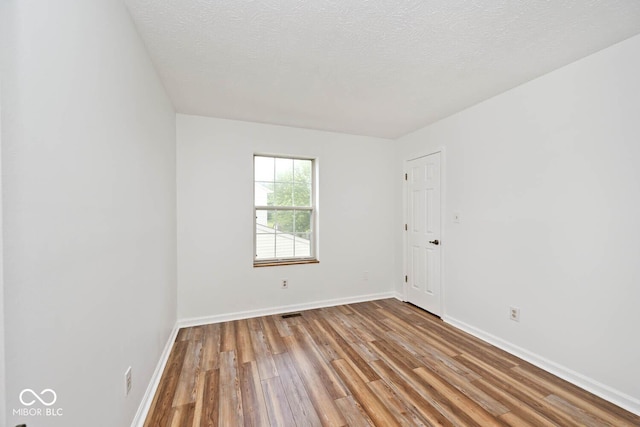 11320 Lynchburg Way, Indianapolis, IN 46229 - spare room with wood finished floors and a textured ceiling