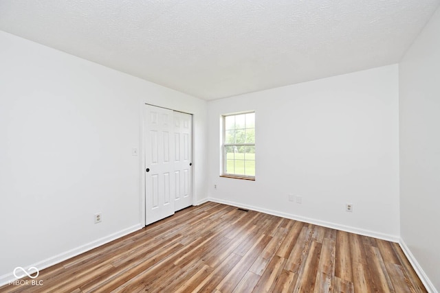 11320 Lynchburg Way, Indianapolis, IN 46229 - spare room with wood finished floors and a textured ceiling