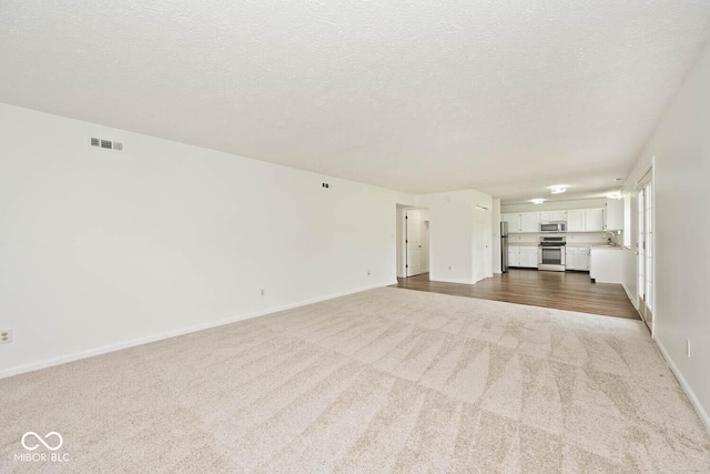 11320 Lynchburg Way, Indianapolis, IN 46229 - unfurnished living room featuring dark colored carpet and a textured ceiling
