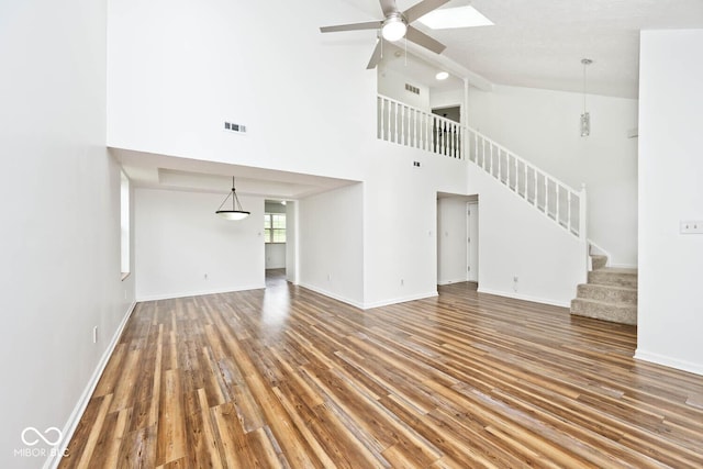 11320 Lynchburg Way, Indianapolis, IN 46229 - unfurnished living room with stairway, ceiling fan, wood finished floors, and high vaulted ceiling