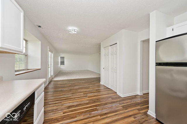 11320 Lynchburg Way, Indianapolis, IN 46229 - kitchen featuring freestanding refrigerator, white cabinets, wood finished floors, light countertops, and a textured ceiling