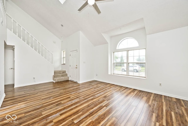 11320 Lynchburg Way, Indianapolis, IN 46229 - unfurnished living room with high vaulted ceiling, wood finished floors, ceiling fan, and stairs