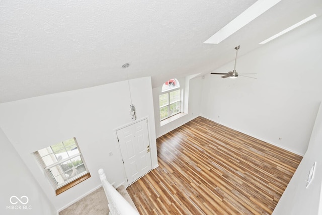 11320 Lynchburg Way, Indianapolis, IN 46229 - entryway featuring lofted ceiling, a skylight, a textured ceiling, ceiling fan, and light wood finished floors