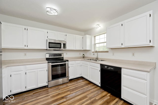 11320 Lynchburg Way, Indianapolis, IN 46229 - kitchen with stainless steel appliances, white cabinetry, light wood-style floors, and light countertops