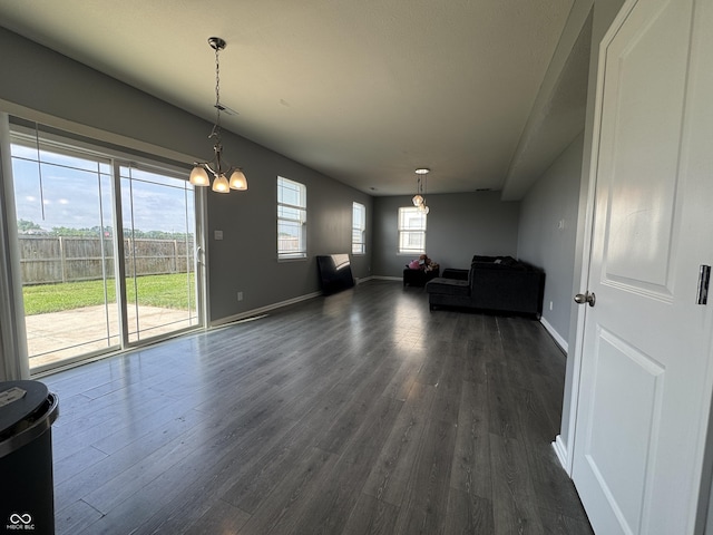 8969 Faulkner Dr, Indianapolis, IN 46239 - unfurnished living room featuring dark wood-style floors and a chandelier