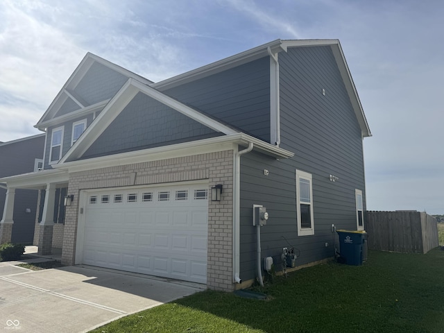 8969 Faulkner Dr, Indianapolis, IN 46239 - view of side of home featuring driveway, brick siding, and an attached garage