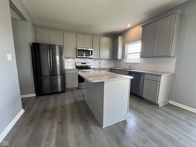 8969 Faulkner Dr, Indianapolis, IN 46239 - kitchen with stainless steel appliances, gray cabinets, dark wood finished floors, tasteful backsplash, and recessed lighting