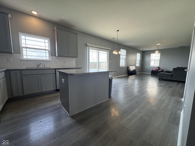 8969 Faulkner Dr, Indianapolis, IN 46239 - kitchen with healthy amount of natural light, gray cabinetry, open floor plan, dark wood finished floors, and recessed lighting