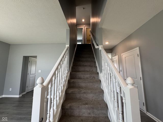 8969 Faulkner Dr, Indianapolis, IN 46239 - stairs featuring a textured ceiling, wood finished floors, and recessed lighting