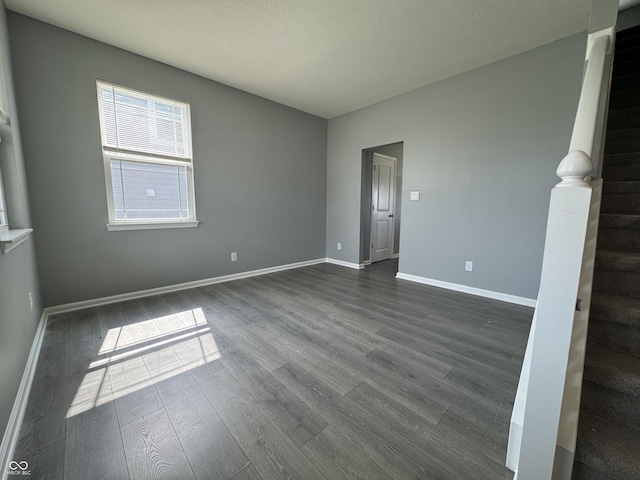 8969 Faulkner Dr, Indianapolis, IN 46239 - empty room featuring dark wood-style floors and stairs