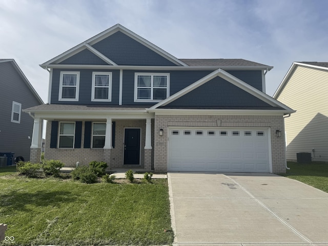 8969 Faulkner Dr, Indianapolis, IN 46239 - craftsman house with driveway, a front lawn, brick siding, and covered porch