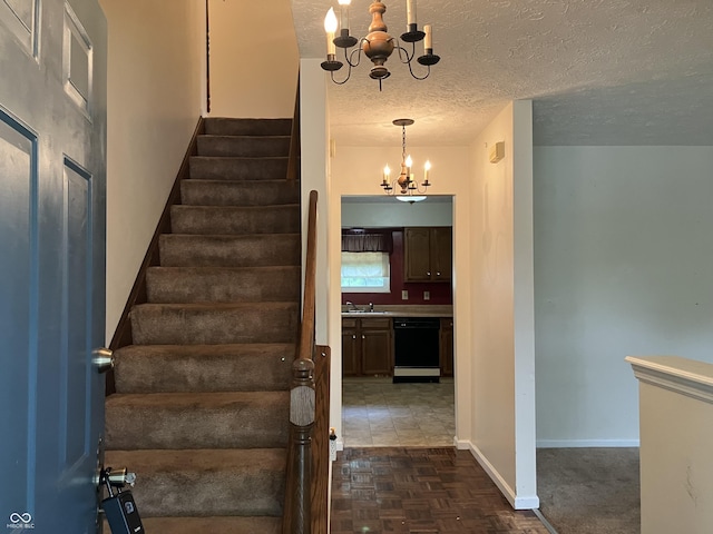 7667 Madden Ln, Fishers, IN 46038 - staircase with a chandelier and a textured ceiling