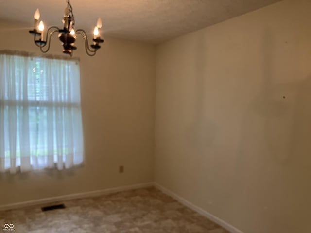 7667 Madden Ln, Fishers, IN 46038 - unfurnished room with a chandelier and baseboards
