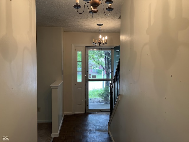 7667 Madden Ln, Fishers, IN 46038 - entryway with a chandelier, a textured ceiling, and stairs
