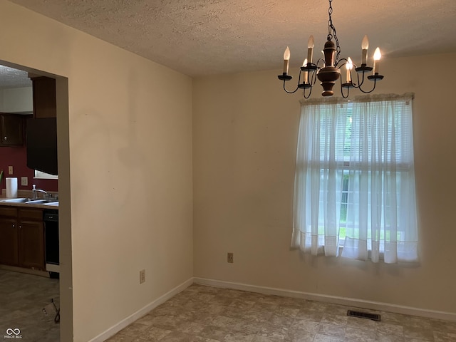 7667 Madden Ln, Fishers, IN 46038 - unfurnished dining area featuring healthy amount of natural light, a chandelier, and a textured ceiling