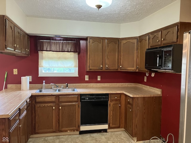 7667 Madden Ln, Fishers, IN 46038 - kitchen featuring black appliances, a textured ceiling, and light countertops
