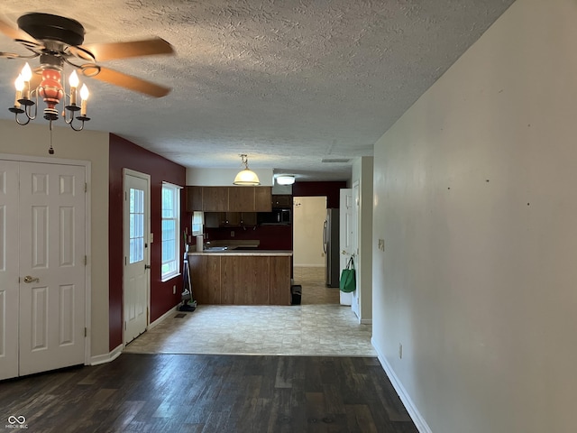 7667 Madden Ln, Fishers, IN 46038 - kitchen featuring wood finished floors, ceiling fan, freestanding refrigerator, open floor plan, and black microwave
