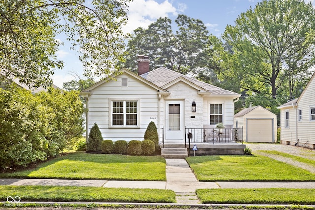6045 Crittenden Ave, Indianapolis, IN 46220 - bungalow-style home with dirt driveway, a chimney, an outbuilding, and a front lawn