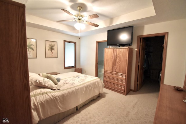 5943 Red Maple Dr, Indianapolis, IN 46237 - carpeted bedroom with a tray ceiling and a ceiling fan