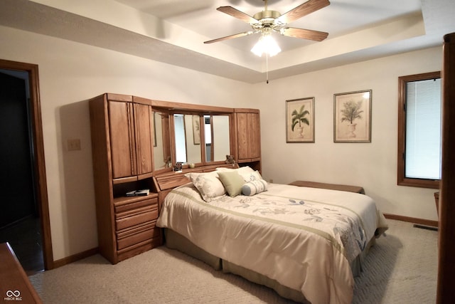 5943 Red Maple Dr, Indianapolis, IN 46237 - bedroom with light carpet, a tray ceiling, and ceiling fan