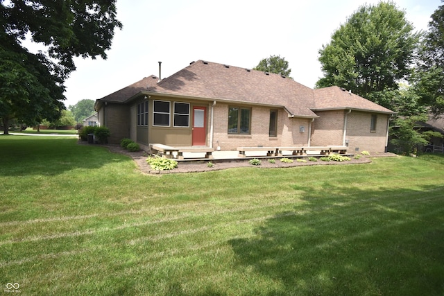 5943 Red Maple Dr, Indianapolis, IN 46237 - rear view of property featuring brick siding, a lawn, and a shingled roof