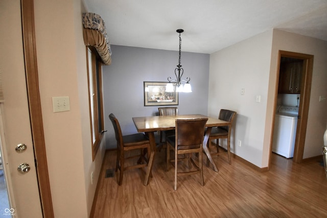 5943 Red Maple Dr, Indianapolis, IN 46237 - dining space with light wood finished floors and a chandelier