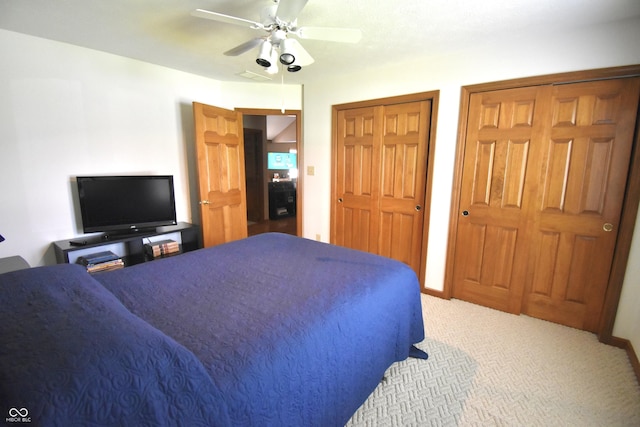 5943 Red Maple Dr, Indianapolis, IN 46237 - carpeted bedroom with multiple closets and ceiling fan