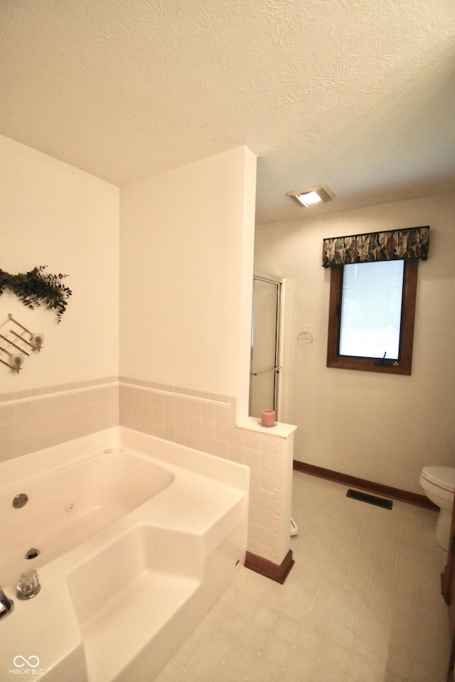 5943 Red Maple Dr, Indianapolis, IN 46237 - bathroom featuring a garden tub, a stall shower, and a textured ceiling
