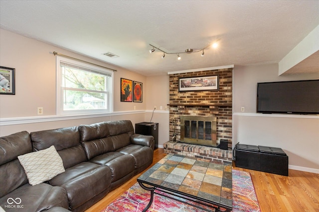 5802 Rymark Ct, Indianapolis, IN 46250 - living area featuring wood finished floors, a fireplace, and a textured ceiling