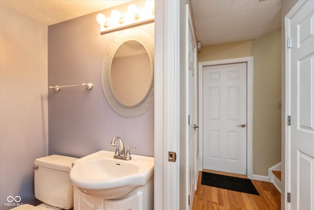 5802 Rymark Ct, Indianapolis, IN 46250 - bathroom featuring wood finished floors, a textured ceiling, and vanity