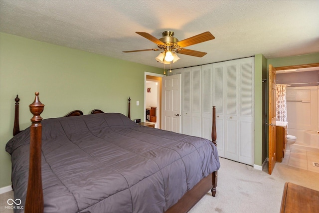 5802 Rymark Ct, Indianapolis, IN 46250 - bedroom with light carpet, a closet, ensuite bathroom, a ceiling fan, and a textured ceiling