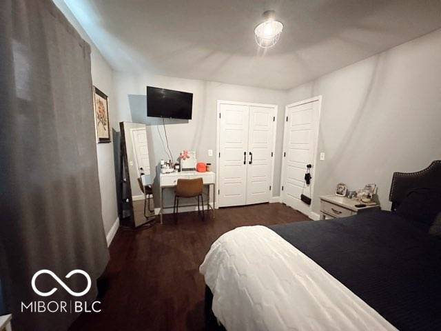 410 Hawthorn Ct, Seymour, IN 47274 - bedroom with a desk and dark wood-style flooring