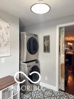 410 Hawthorn Ct, Seymour, IN 47274 - laundry room with stacked washer and clothes dryer and baseboards