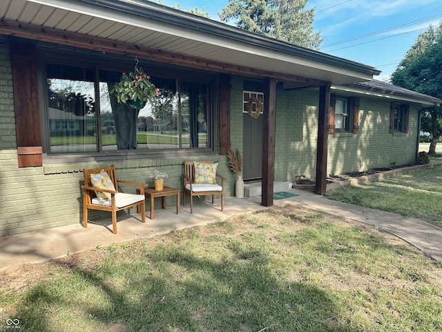 410 Hawthorn Ct, Seymour, IN 47274 - back of property featuring brick siding and a lawn