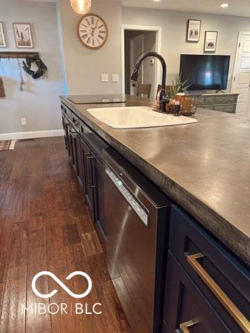 410 Hawthorn Ct, Seymour, IN 47274 - kitchen featuring stainless steel dishwasher, dark wood-style flooring, recessed lighting, and dark countertops
