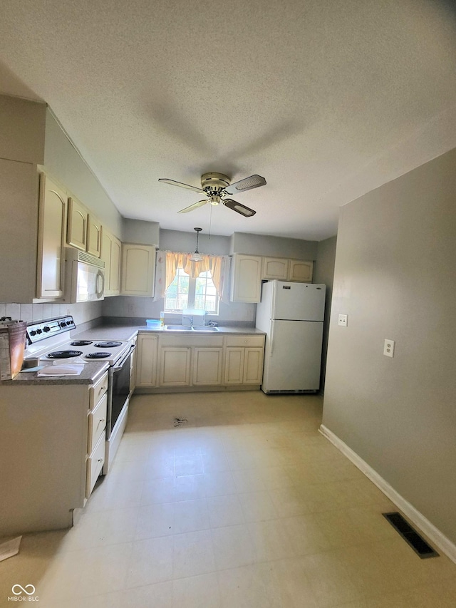 7576 S Carlisle St, Terre Haute, IN 47802 - kitchen with white appliances, a ceiling fan, cream cabinetry, and a textured ceiling