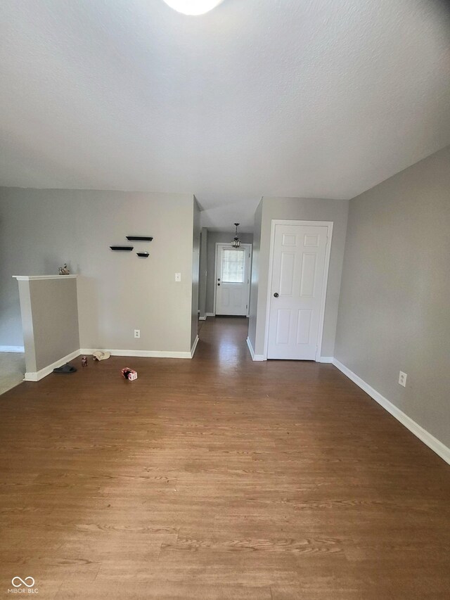 7576 S Carlisle St, Terre Haute, IN 47802 - unfurnished living room featuring wood finished floors and baseboards