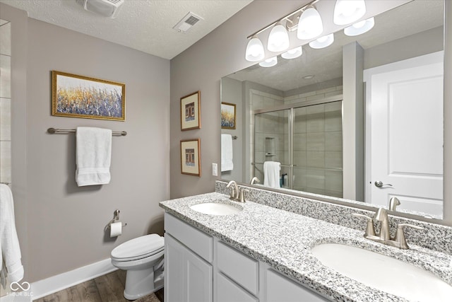 14442 Treasure Creek Ln, Fishers, IN 46038 - bathroom featuring wood finished floors, double vanity, a stall shower, and a textured ceiling