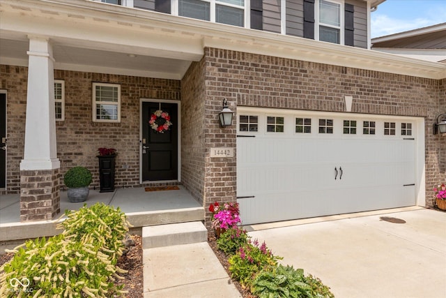 14442 Treasure Creek Ln, Fishers, IN 46038 - property entrance with brick siding, driveway, and a porch